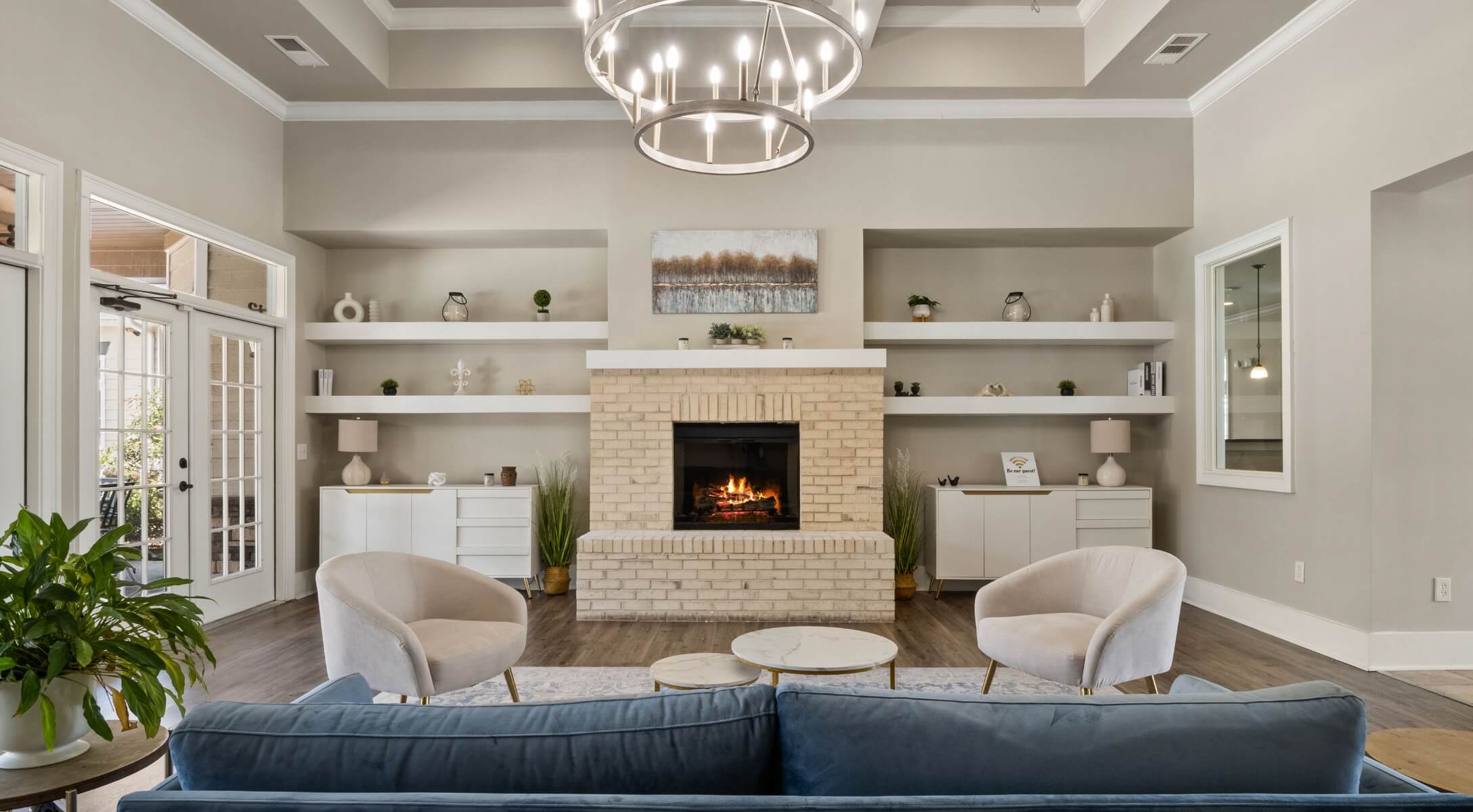 the ansley place community seating and lounging area with a fireplace and luxurious furniture